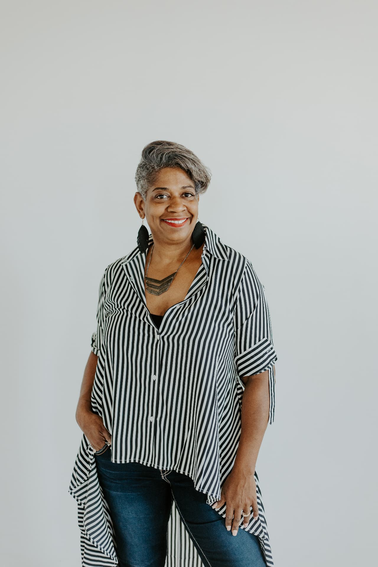 Cecilia Stanton Adams, Founder & Turning Point Strategist, standing in a striped blouse